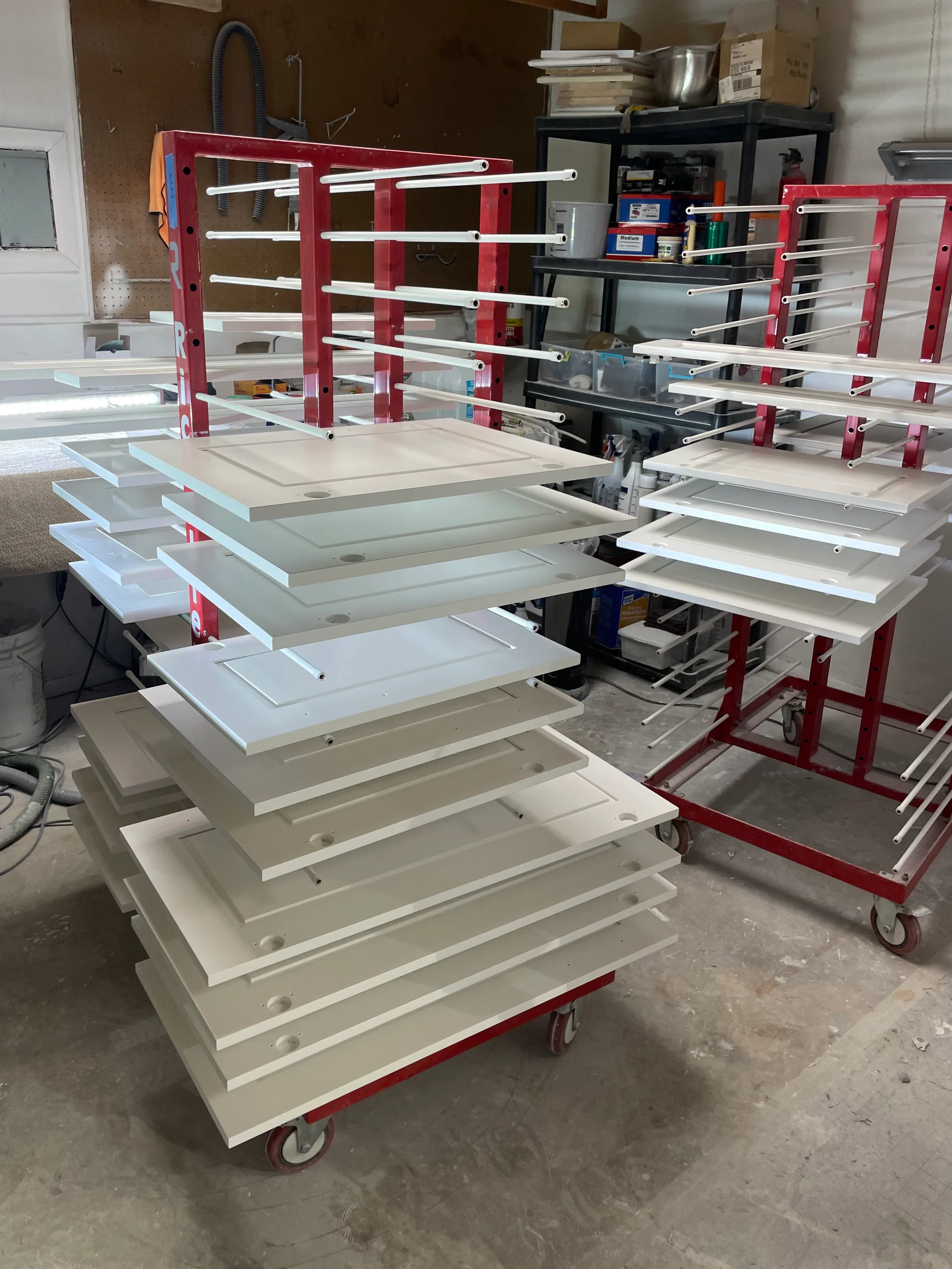 Cabinet doors on drying rack with portable booth containment