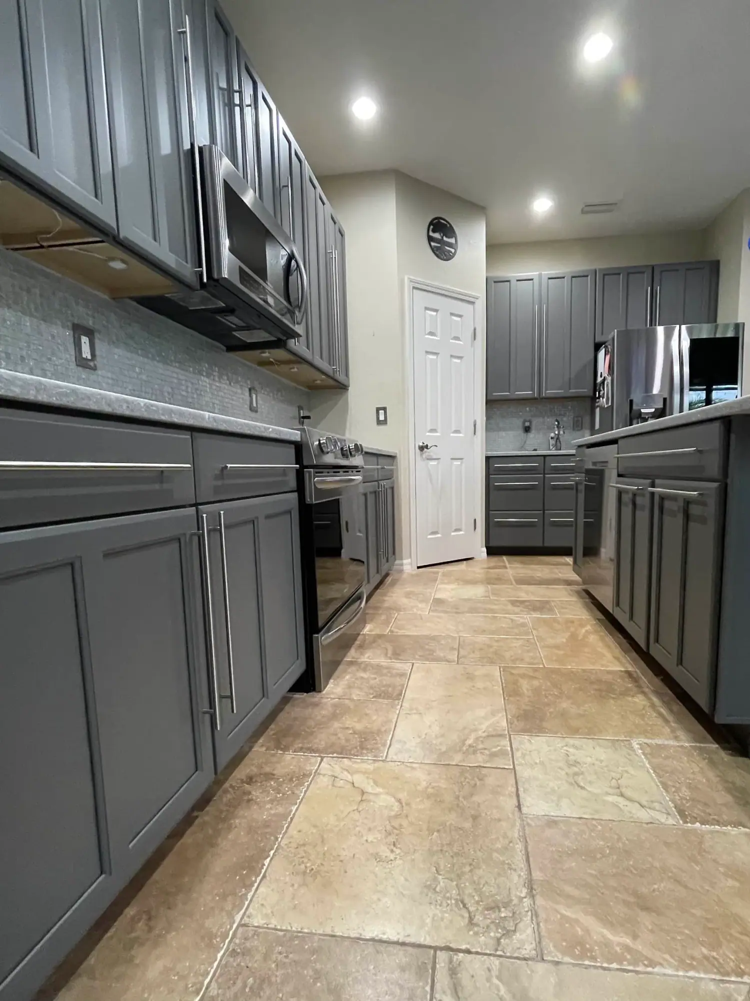 Charcoal painted cabinets with brass hardware in Sarasota kitchen