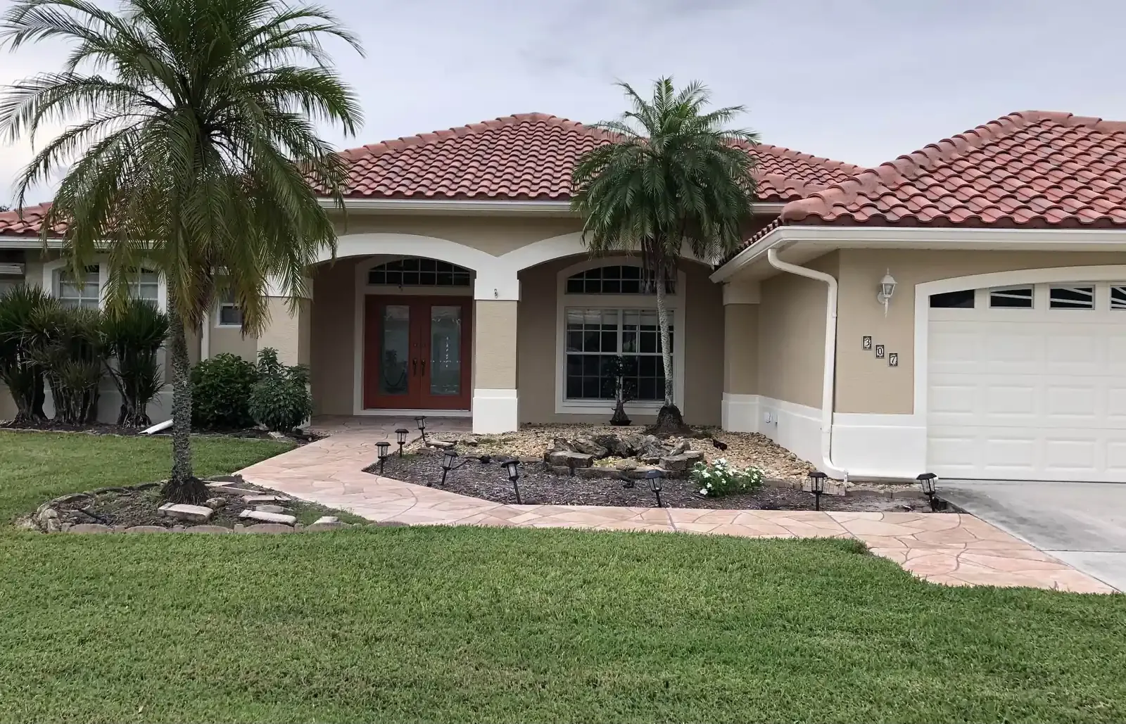 Stucco repaint with stained door and trim