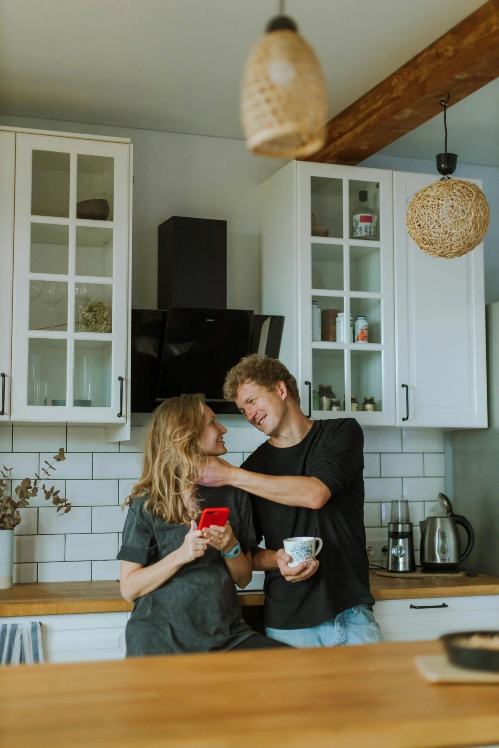 Sarasota homeowners admiring newly painted white kitchen cabinets