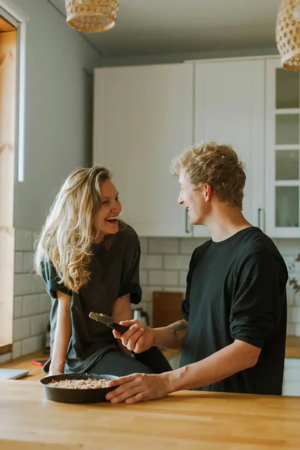 Sarasota homeowners smiling together in a newly refinished kitchen