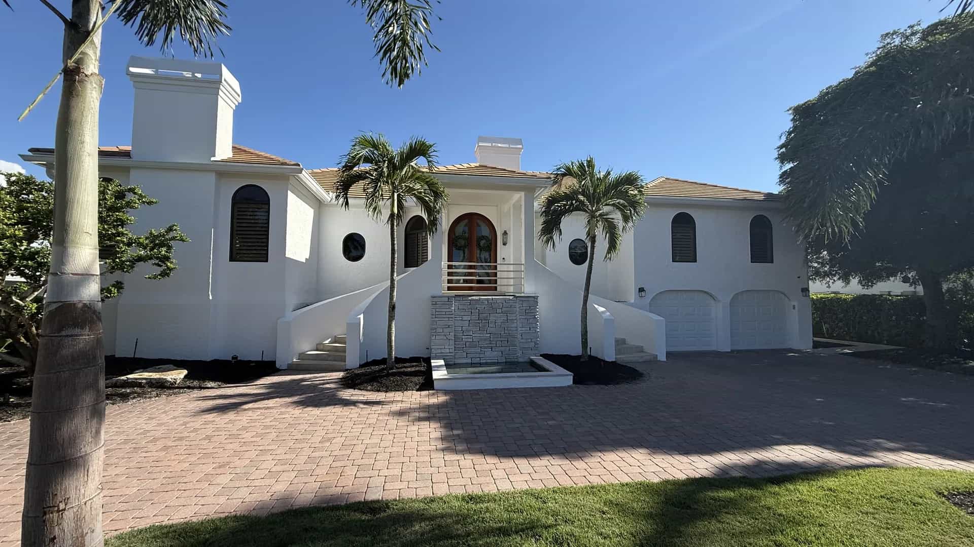 Licensed painting contractor crew completing a Sarasota home with professional equipment and staging