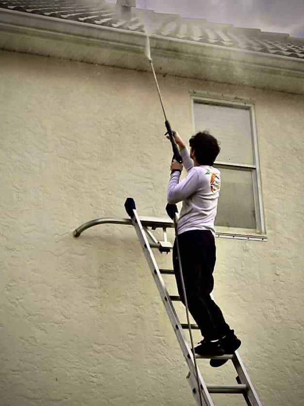 Pressure washing prep on a painted Florida exterior
