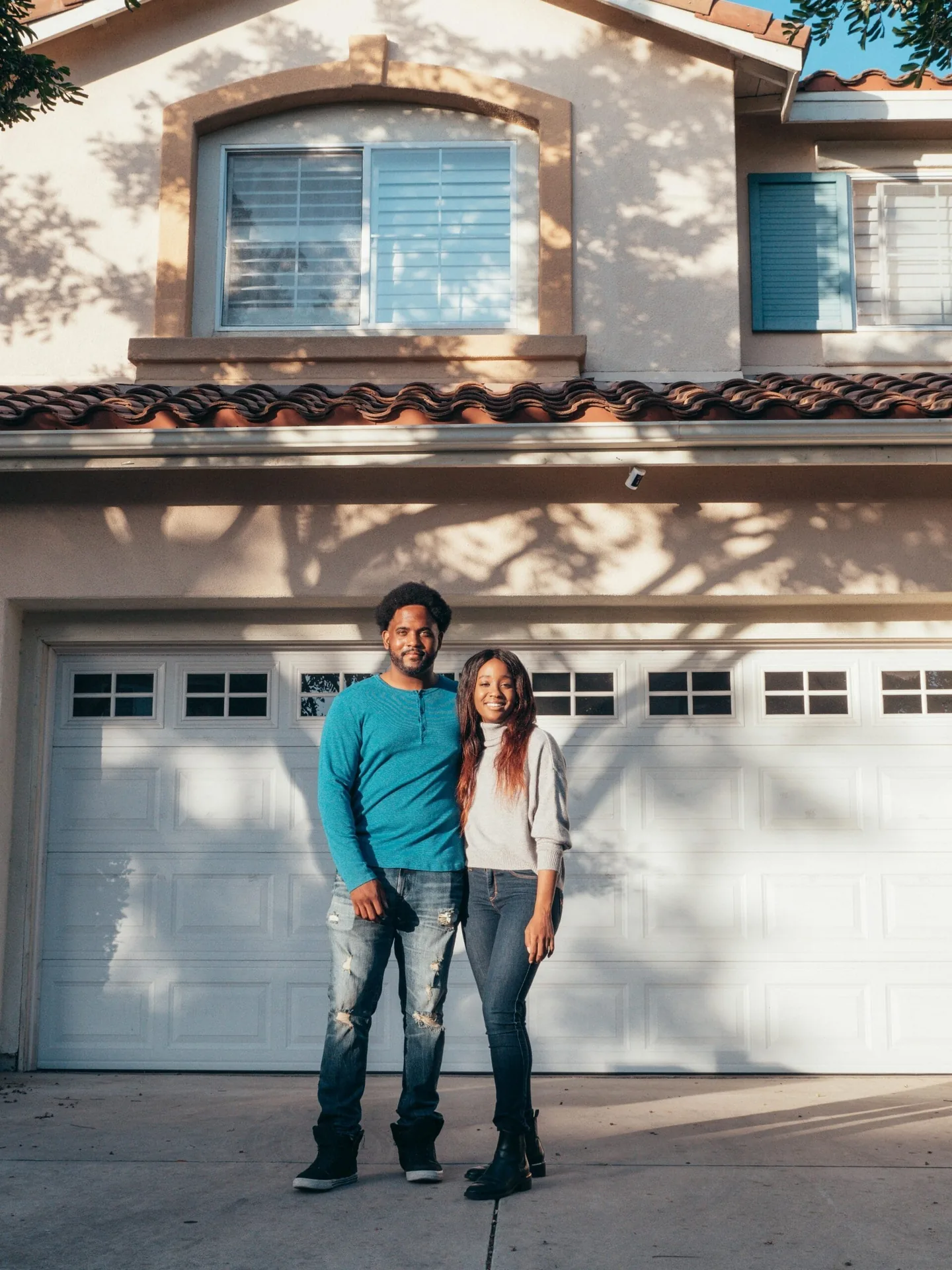 Sarasota couple standing in front of their newly painted home exterior